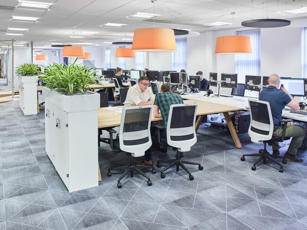 Office Refurbishment at RG+P Architects, showing an open-plan office with large hot-desks and office greenery.