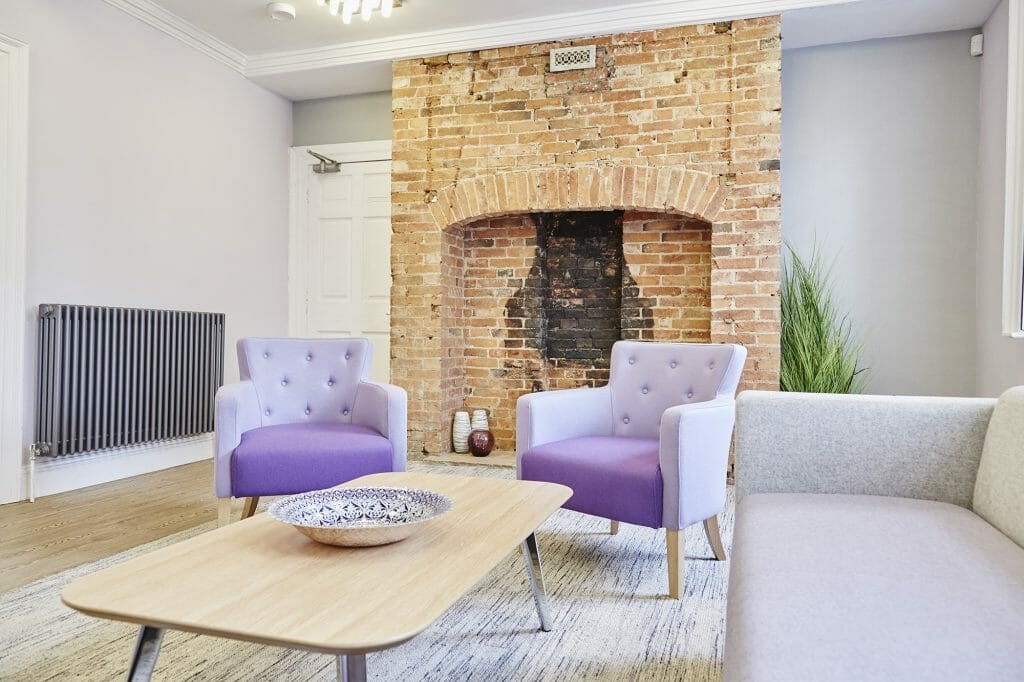 Office refurbishment of DB Wood Investment Management, showing two purple armchairs and a coffee table