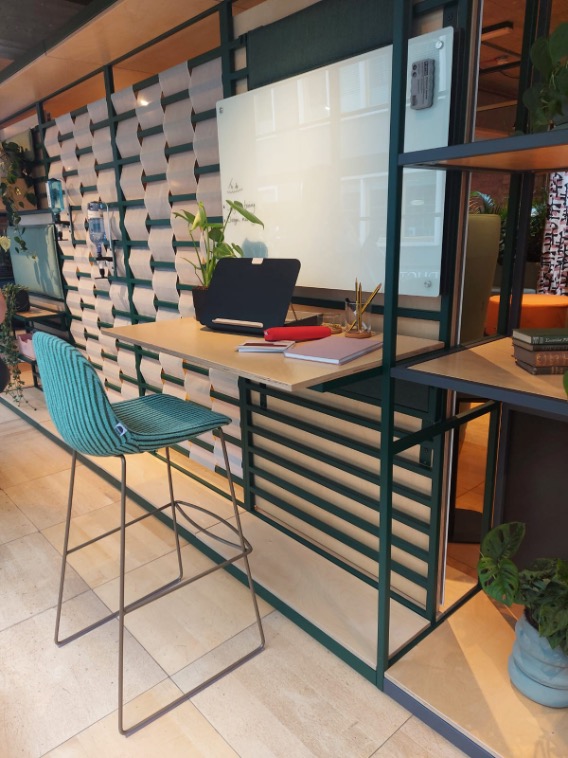 A flexible stool and desk set up with whiteboard at clerkenwell design week.